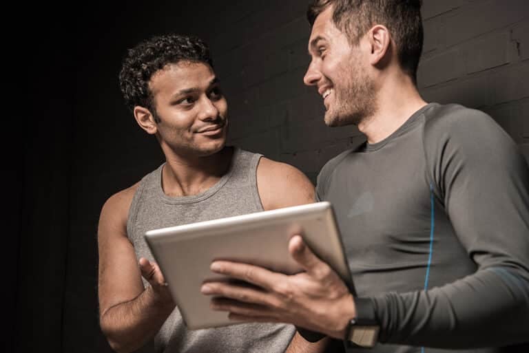 Handsome young men using tablet computer together