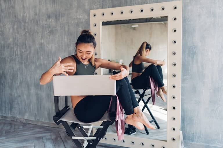 young woman indoors sitting director's chair posing