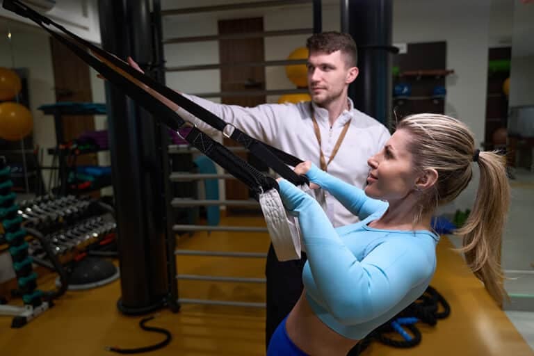 Young female athlete exercising in fitness club