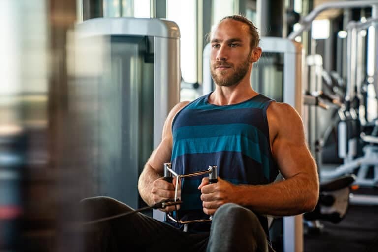 Young muscular man during workout in the gym