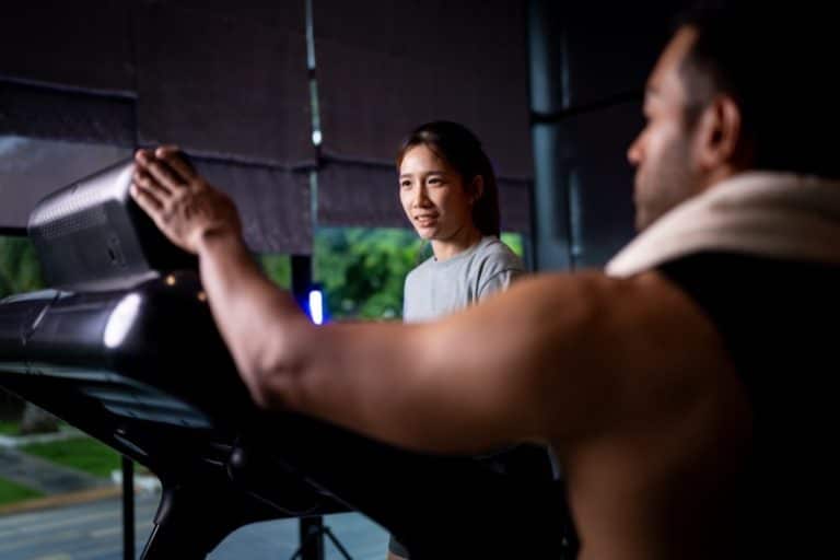 Asian man and woman working out, one is a trainer, the other is an exerciser