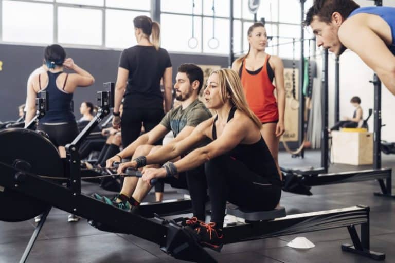 People using rowing machines in in gym